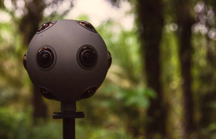 a 360 degree camera against the backdrop of a forest