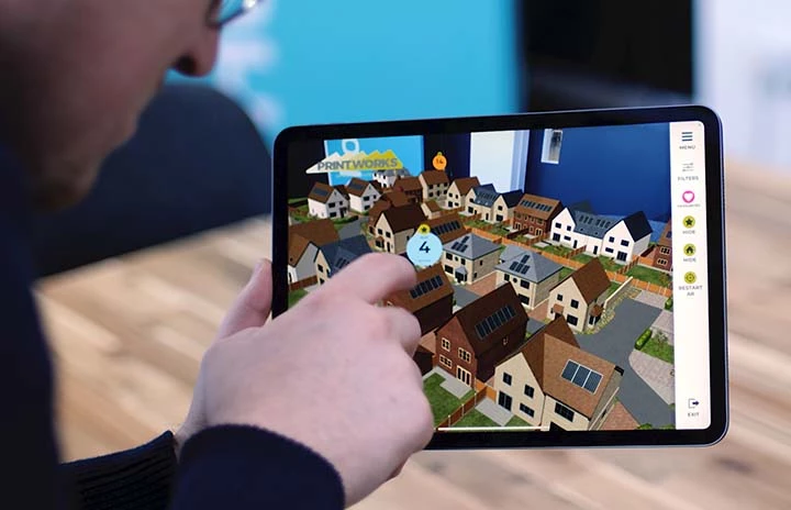 An ipad using the AR camera to view a housing development