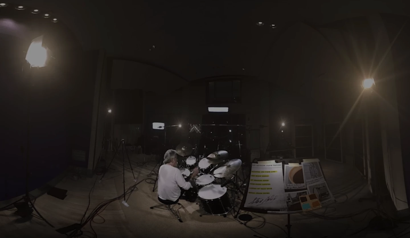 a drummer in a dark recording studio