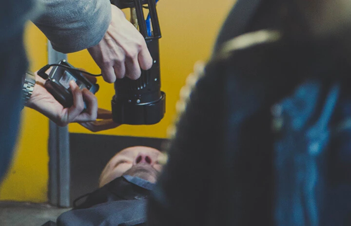 someone using a camera to photo an actor playing dead