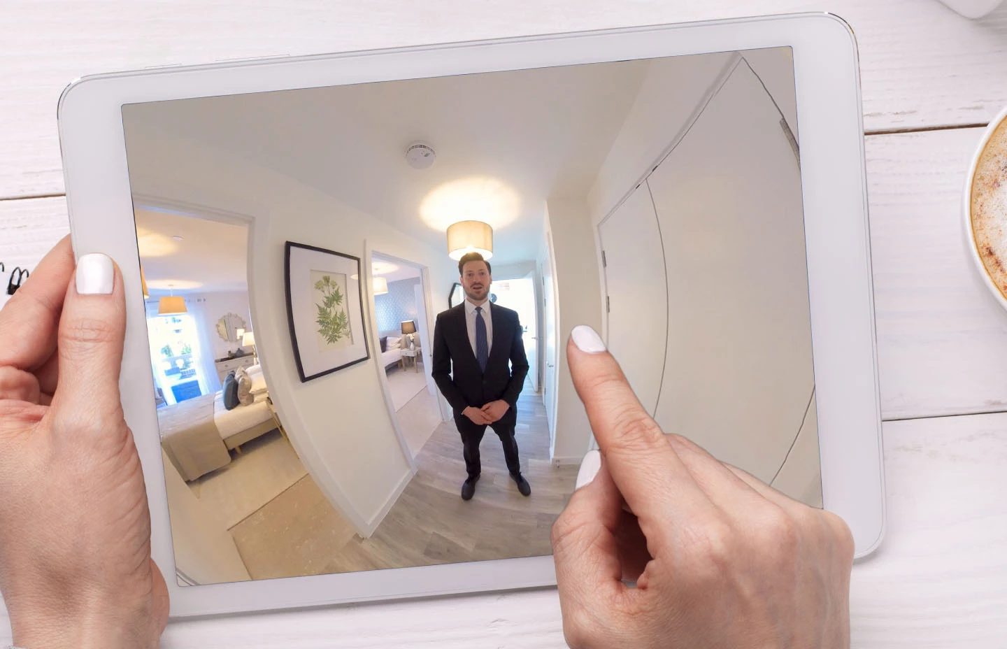 an ipad screen with a picture of a man in a suit standing in a hallway