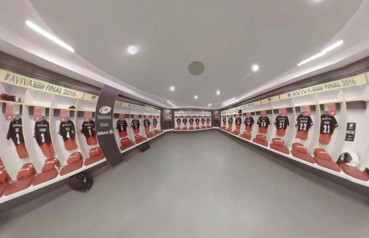 Rugby changing room with folded kit on the walls