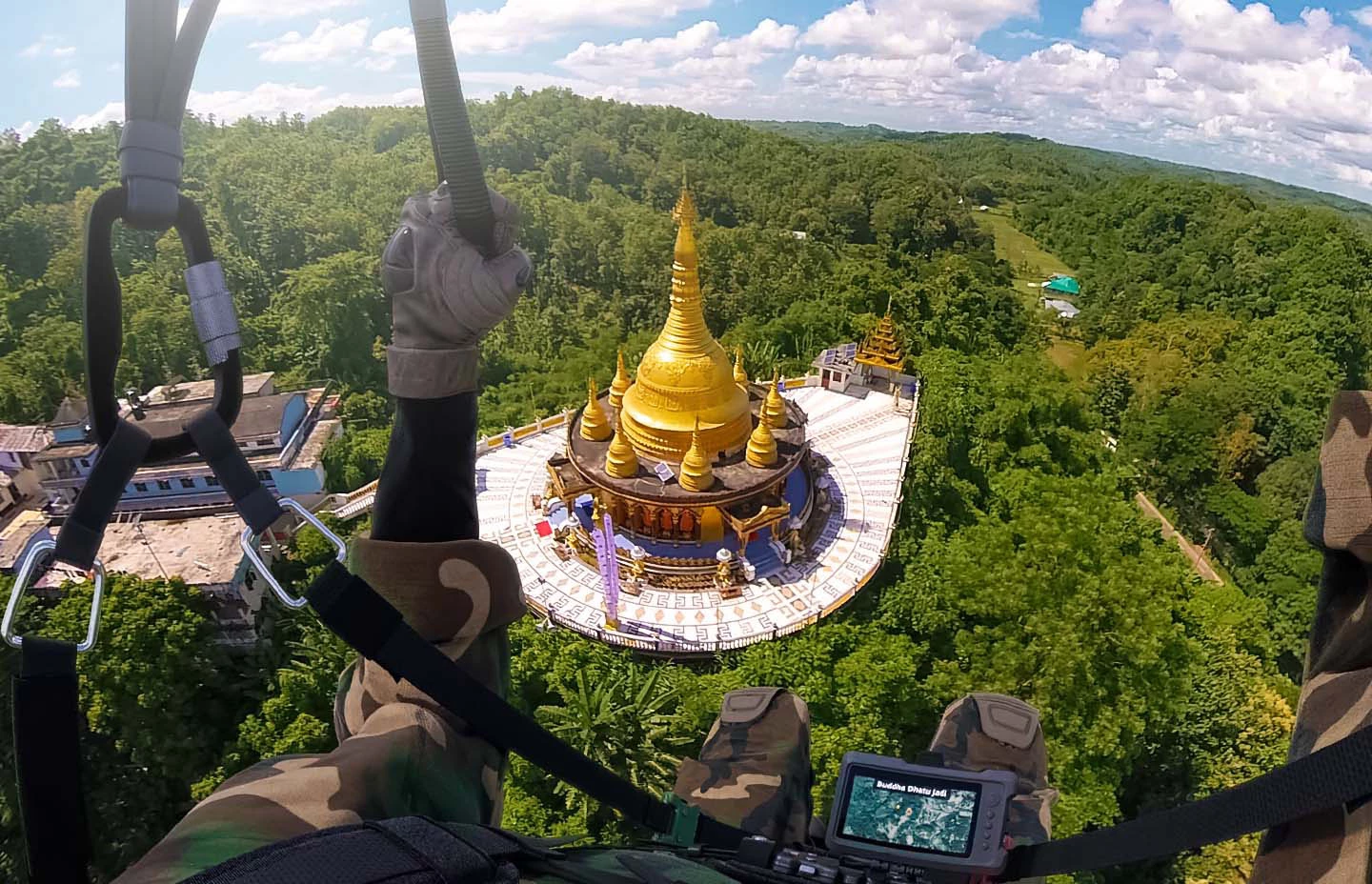 First person view paragliding over a golden temple in the Bangladesh jungle