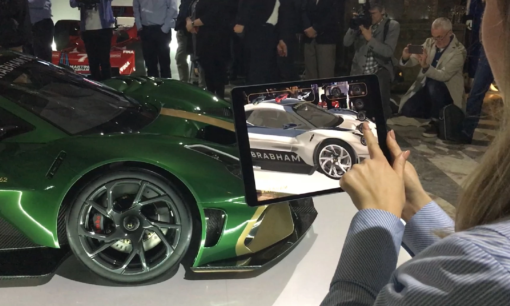 An ipad using the AR camera to view a sports car with different colours