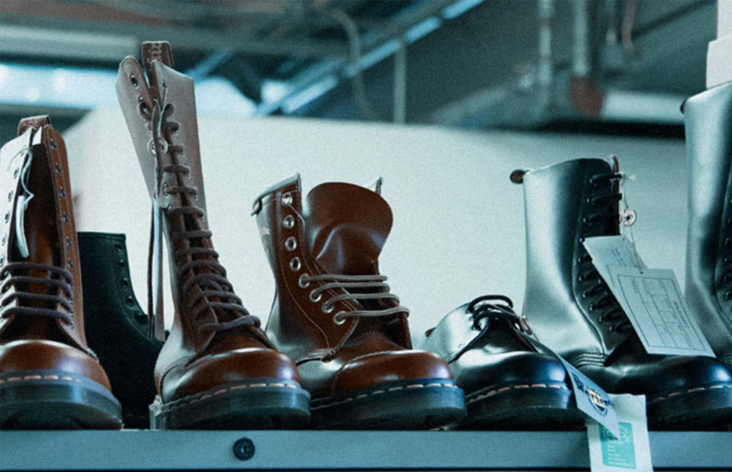 Collection of Dr Martens boots for sale on a shelf