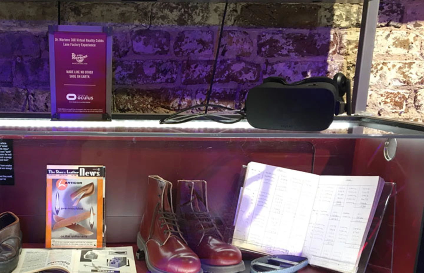 Shelves displaying Dr Martens shoes, logbook, magazines and VR headset
