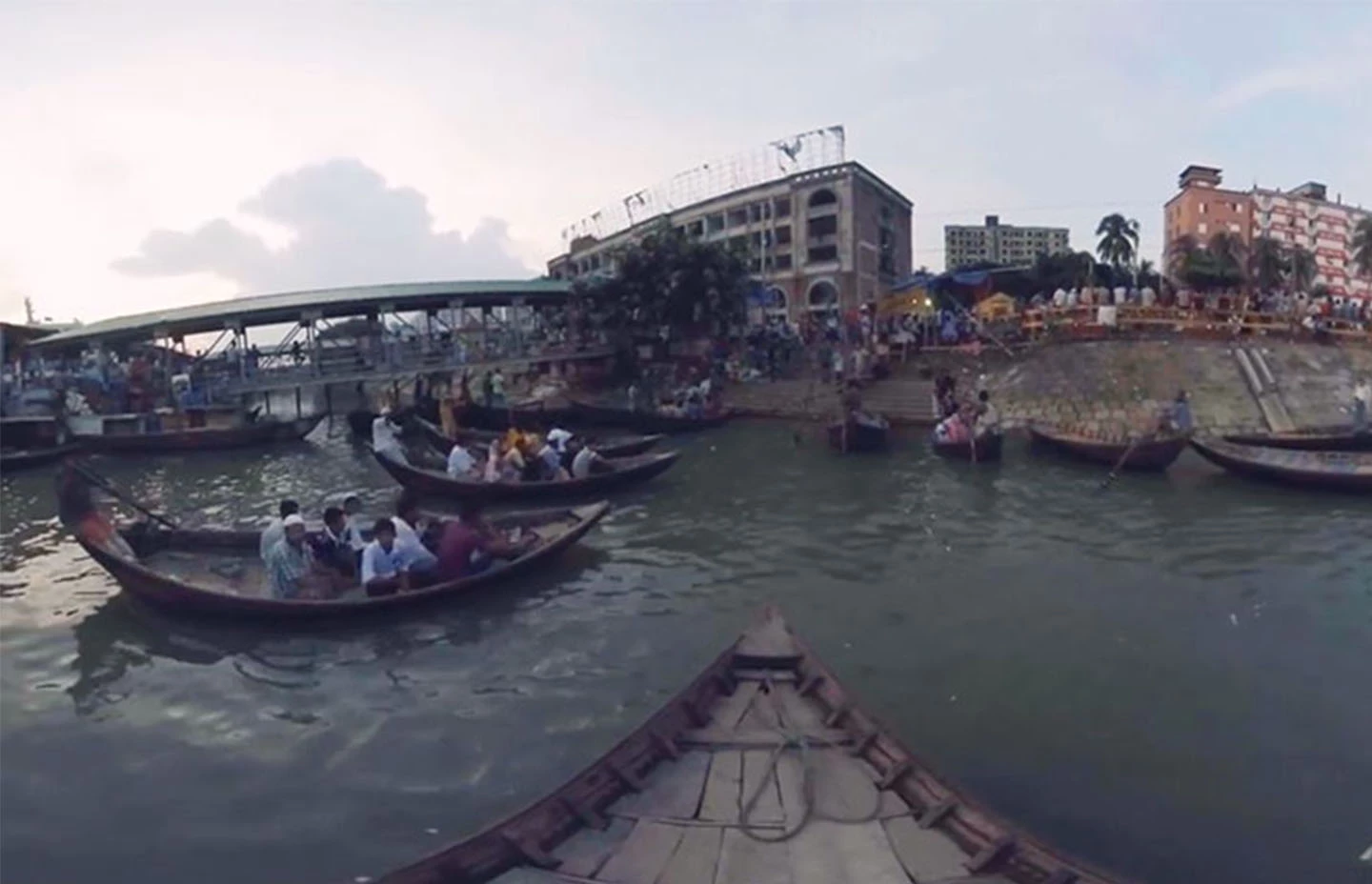 First person view on the front of a gondola boat floating on a busy river