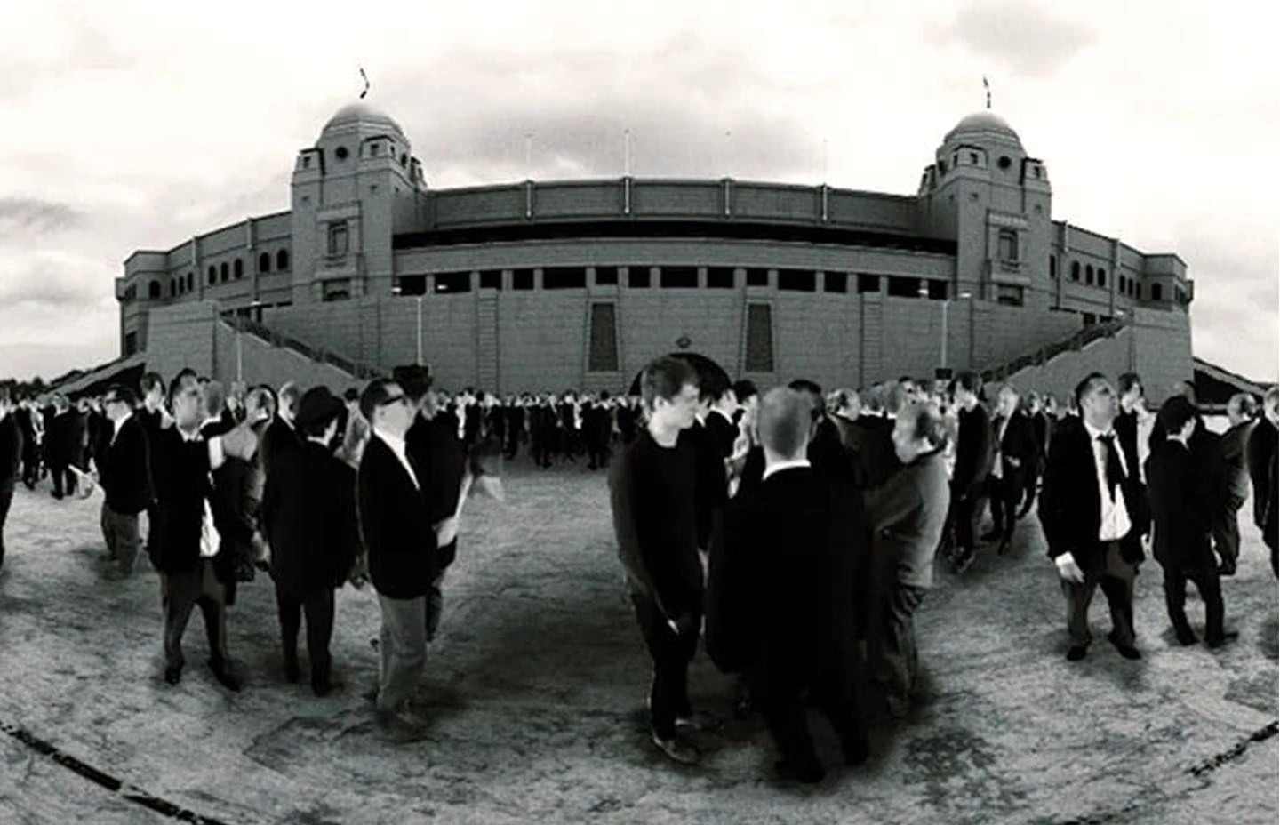 Black and white image of fans outside West Ham United football stadium