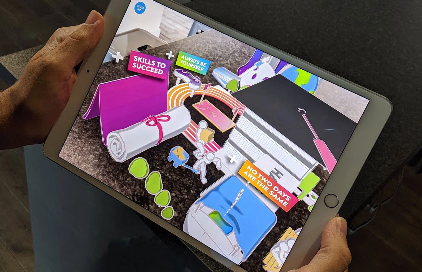 An ipad using the AR camera to view a University experience