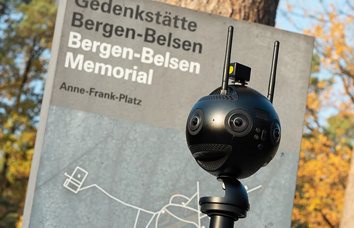 a 360 degree camera in front of a memorial