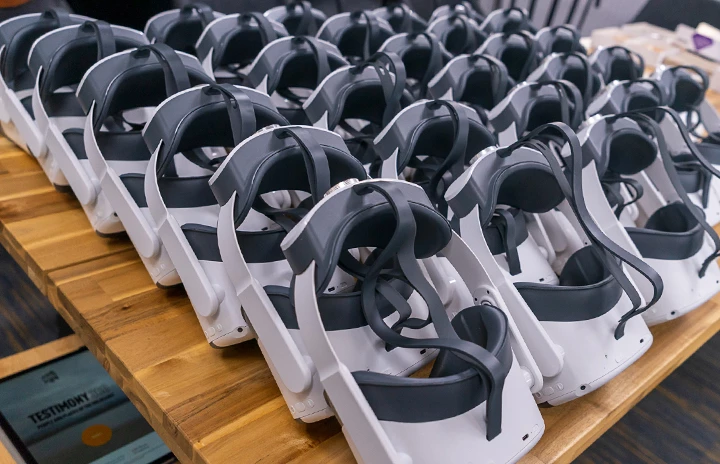 a table full of VR headsets lined up