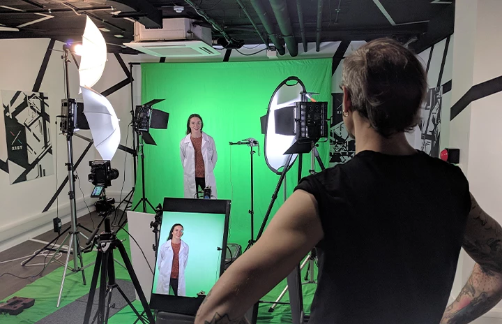 A Green screen film studio filming someone in a labcoat