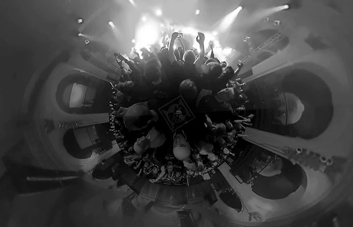 a 360 degree image from a metal show in black and white