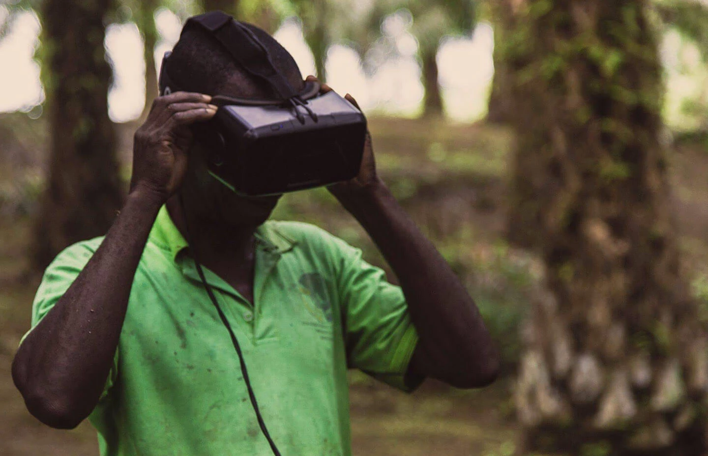 a man in a jungle wearing a VR headset