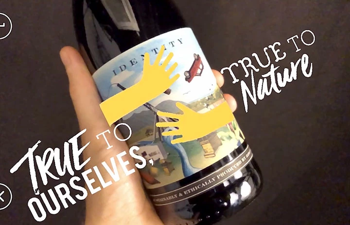 a hand holding a bottle of wine with some branded graphics
