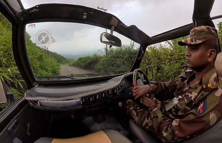 a POV shot of a soldier driving a jeep