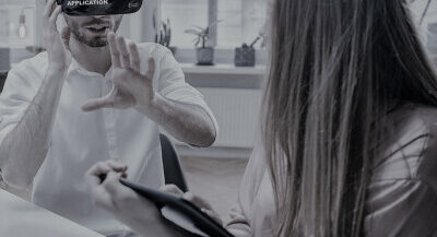 Man-in-headset-with-woman-taking-notes